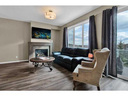 248 Sunset Point, Cochrane, AB - Indoor Photo Showing Living Room With Fireplace