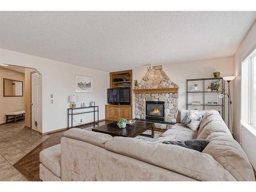 284 Mt Brewster Circle Se, Calgary, AB - Indoor Photo Showing Living Room With Fireplace