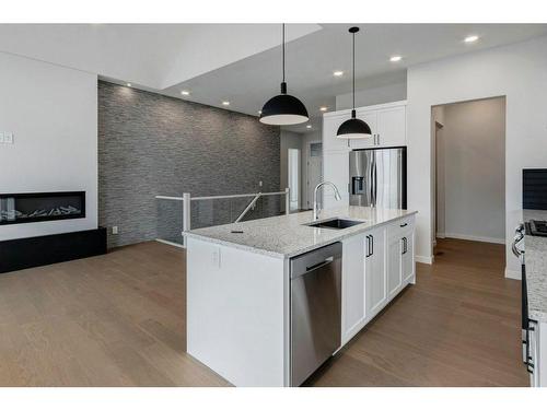 802 Mandalay Link, Carstairs, AB - Indoor Photo Showing Kitchen With Fireplace With Upgraded Kitchen