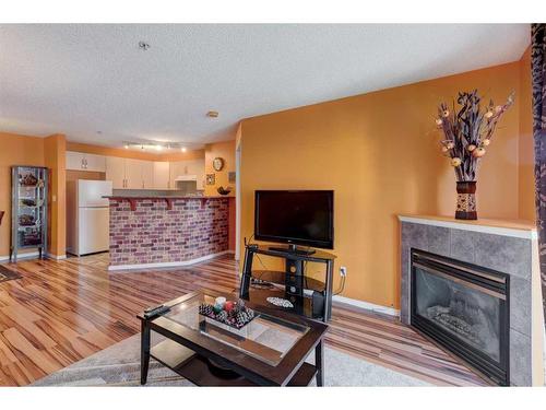 4214-4975 130 Avenue Se, Calgary, AB - Indoor Photo Showing Living Room With Fireplace