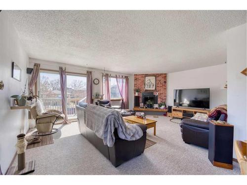 210, 212 31 Avenue Ne, Calgary, AB - Indoor Photo Showing Living Room With Fireplace