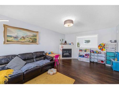 100 Country Hills Cove Nw, Calgary, AB - Indoor Photo Showing Living Room With Fireplace
