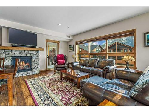 303-905 Spring Creek Drive, Canmore, AB - Indoor Photo Showing Living Room With Fireplace