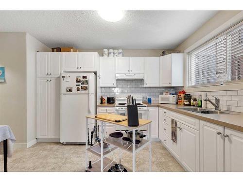 6131 Bowness Road Nw, Calgary, AB - Indoor Photo Showing Kitchen With Double Sink