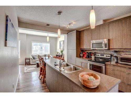 124 Marquis Lane Se, Calgary, AB - Indoor Photo Showing Kitchen With Double Sink