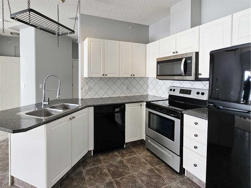 414-345 Rocky Vista Park Nw, Calgary, AB - Indoor Photo Showing Kitchen With Double Sink