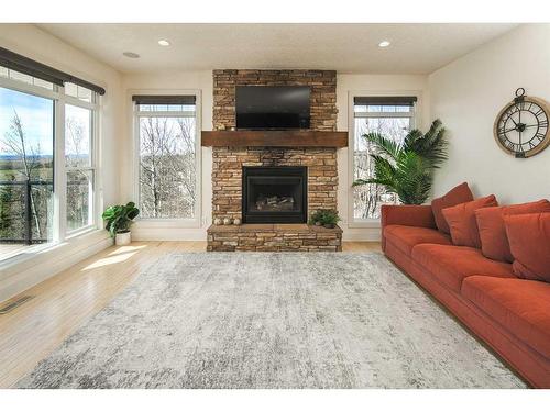 222 Tremblant Place Sw, Calgary, AB - Indoor Photo Showing Living Room With Fireplace