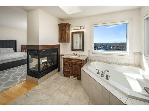 222 Tremblant Place Sw, Calgary, AB - Indoor Photo Showing Bathroom With Fireplace
