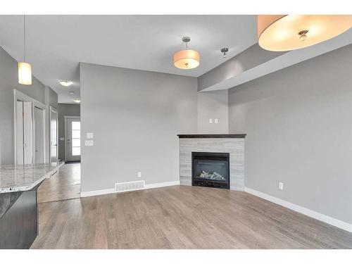 540 Redstone View Ne, Calgary, AB - Indoor Photo Showing Living Room With Fireplace