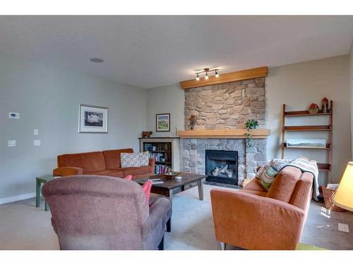 144 Westland Street, Okotoks, AB - Indoor Photo Showing Living Room With Fireplace