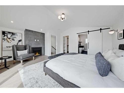 1407 10 Avenue Se, Calgary, AB - Indoor Photo Showing Bedroom With Fireplace