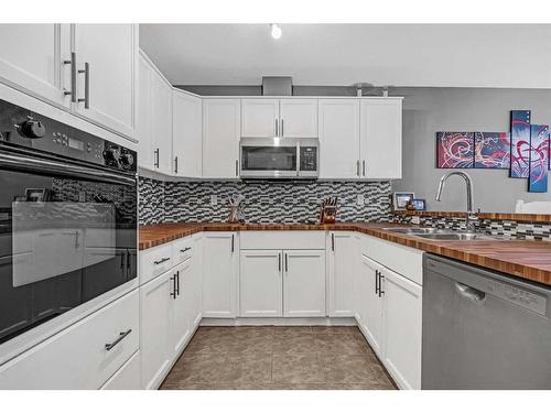 25 Tucker Circle, Okotoks, AB - Indoor Photo Showing Kitchen With Double Sink
