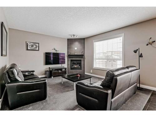 161 Rainbow Falls Heath, Chestermere, AB - Indoor Photo Showing Living Room With Fireplace
