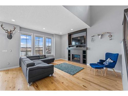 153 Marquis Point Se, Calgary, AB - Indoor Photo Showing Living Room With Fireplace