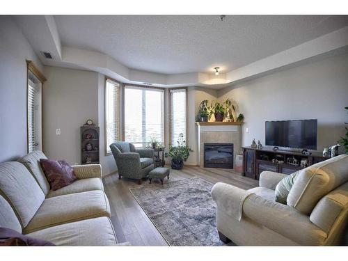 103-15 Everstone Drive Sw, Calgary, AB - Indoor Photo Showing Living Room With Fireplace