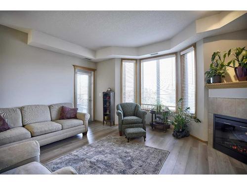 103-15 Everstone Drive Sw, Calgary, AB - Indoor Photo Showing Living Room With Fireplace
