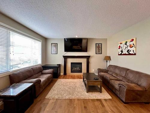 1603 Monteith Drive Se, High River, AB - Indoor Photo Showing Living Room With Fireplace