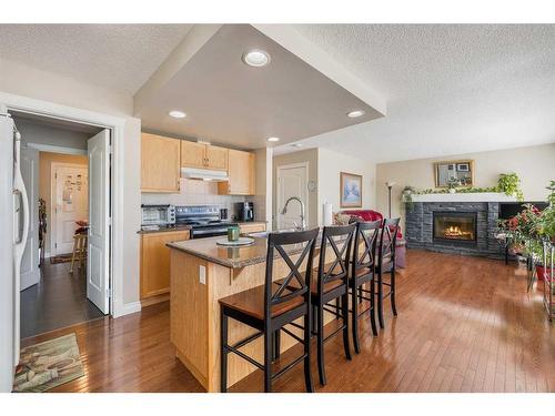 404 Rainbow Falls Way, Chestermere, AB - Indoor Photo Showing Kitchen With Fireplace