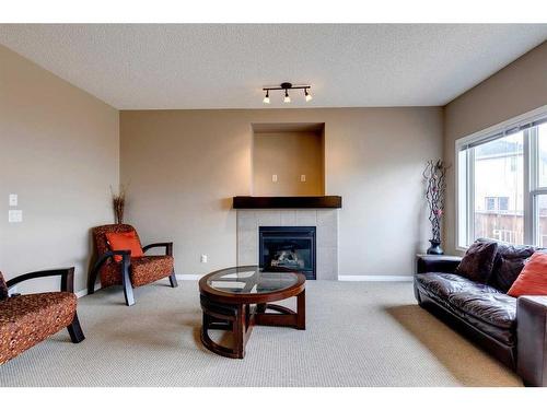 321 Bridleridge View Sw, Calgary, AB - Indoor Photo Showing Living Room With Fireplace