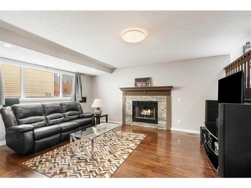 245 Sandstone Drive Nw, Calgary, AB - Indoor Photo Showing Living Room With Fireplace