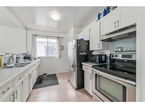 6618 & 6620 Bowness Road Nw, Calgary, AB - Indoor Photo Showing Kitchen With Double Sink