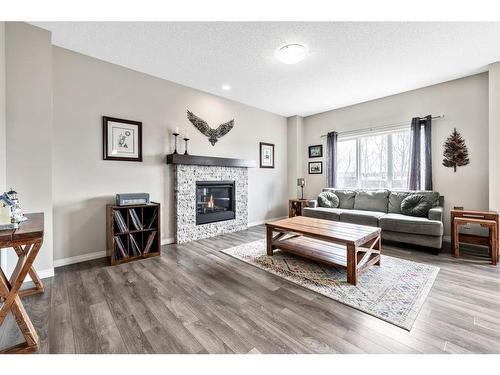 67 Buckskin Way, Cochrane, AB - Indoor Photo Showing Living Room With Fireplace