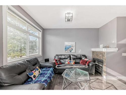 83 Panatella Hill Nw, Calgary, AB - Indoor Photo Showing Living Room With Fireplace
