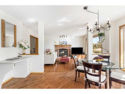 14220 Evergreen Street Sw, Calgary, AB - Indoor Photo Showing Dining Room With Fireplace