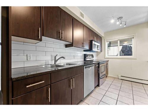 7-1622 28 Avenue Sw, Calgary, AB - Indoor Photo Showing Kitchen With Stainless Steel Kitchen With Double Sink
