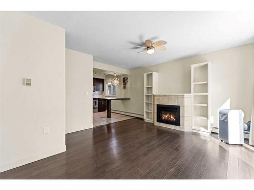 7-1622 28 Avenue Sw, Calgary, AB - Indoor Photo Showing Living Room With Fireplace