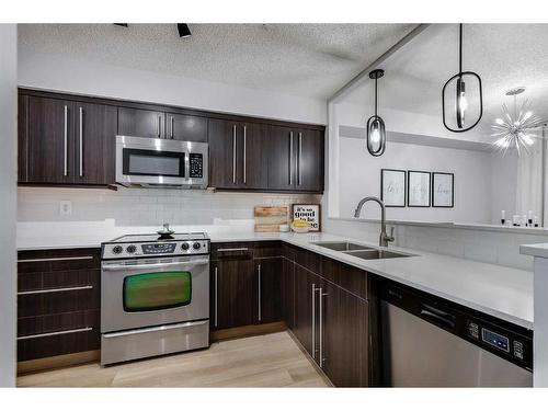 405-225 25 Avenue Sw, Calgary, AB - Indoor Photo Showing Kitchen With Stainless Steel Kitchen With Double Sink