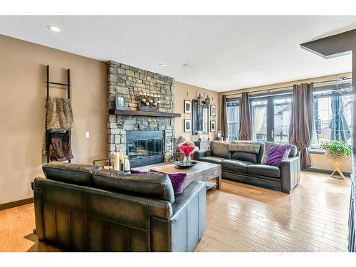 100 Cougar Ridge Manor Sw, Calgary, AB - Indoor Photo Showing Living Room With Fireplace