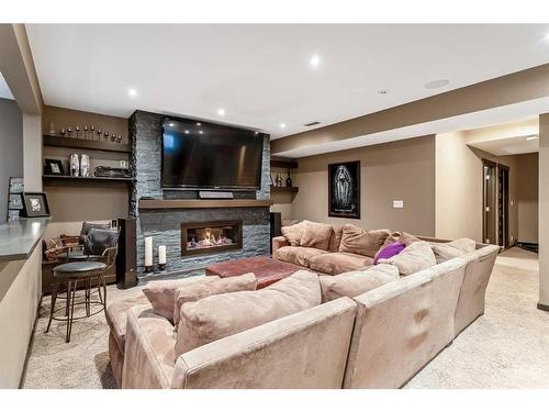 100 Cougar Ridge Manor Sw, Calgary, AB - Indoor Photo Showing Living Room With Fireplace
