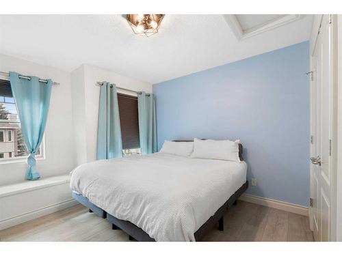 724 14A Street Se, Calgary, AB - Indoor Photo Showing Bedroom With Fireplace