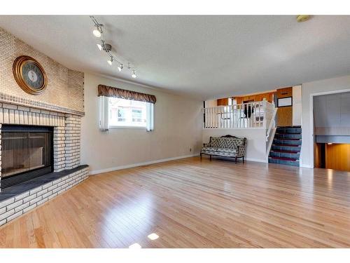 12 Hawkfield Rise Nw, Calgary, AB - Indoor Photo Showing Living Room With Fireplace