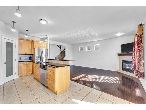 51 Taracove Estate Drive Ne, Calgary, AB - Indoor Photo Showing Kitchen With Fireplace