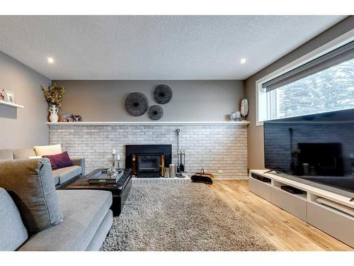 252 Cantrell Drive Sw, Calgary, AB - Indoor Photo Showing Living Room With Fireplace
