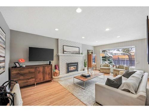 135 Waterloo Drive Sw, Calgary, AB - Indoor Photo Showing Living Room With Fireplace