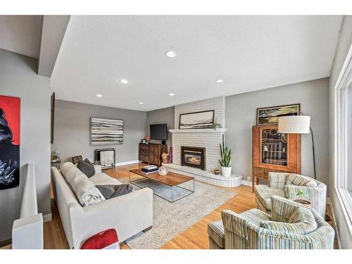 135 Waterloo Drive Sw, Calgary, AB - Indoor Photo Showing Living Room With Fireplace