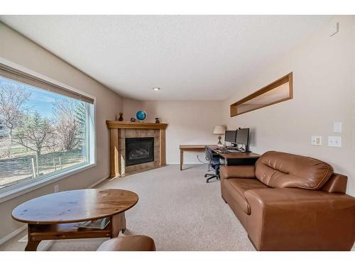 232 Everwillow Green Sw, Calgary, AB - Indoor Photo Showing Living Room With Fireplace