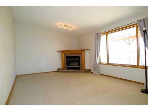173 1 Avenue, Irricana, AB - Indoor Photo Showing Living Room With Fireplace