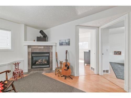 87 Arbour Meadows Close Nw, Calgary, AB - Indoor Photo Showing Living Room With Fireplace