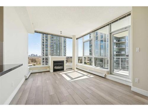 703-55 Spruce Place Sw, Calgary, AB - Indoor With Fireplace