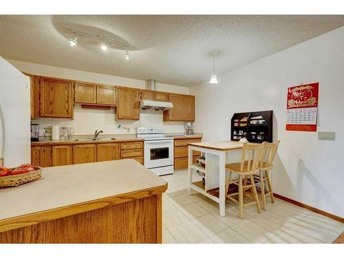 253 Arbour Cliff Close Nw, Calgary, AB - Indoor Photo Showing Kitchen With Double Sink