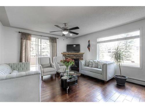 1106-7451 Springbank Boulevard Sw, Calgary, AB - Indoor Photo Showing Living Room With Fireplace