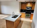 3107-5605 Henwood Street Sw, Calgary, AB  - Indoor Photo Showing Kitchen With Double Sink 