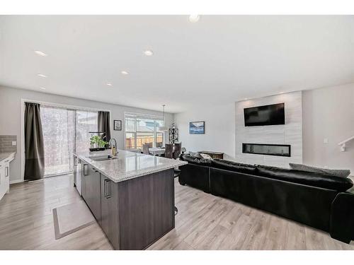 23 Walgrove Link Se, Calgary, AB - Indoor Photo Showing Kitchen With Fireplace With Double Sink