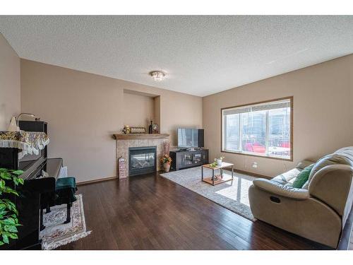 103 Panatella Boulevard Nw, Calgary, AB - Indoor Photo Showing Living Room With Fireplace