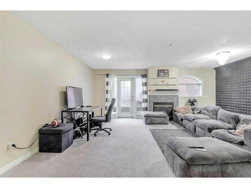 109-923 15 Avenue Sw, Calgary, AB - Indoor Photo Showing Living Room With Fireplace