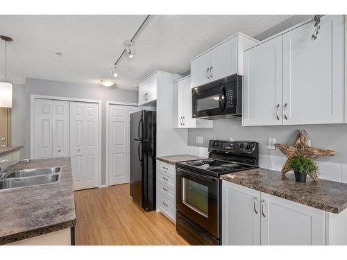 2130-700 Willowbrook Road Nw, Airdrie, AB - Indoor Photo Showing Kitchen With Double Sink